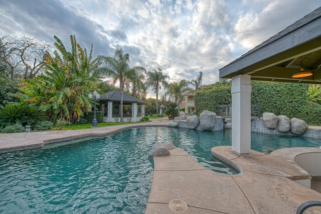 outdoor pool with a patio and a gazebo