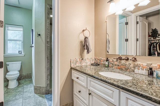 full bath with tile patterned flooring, baseboards, vanity, and toilet