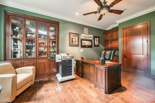 office space featuring light wood-type flooring, ceiling fan, and ornamental molding