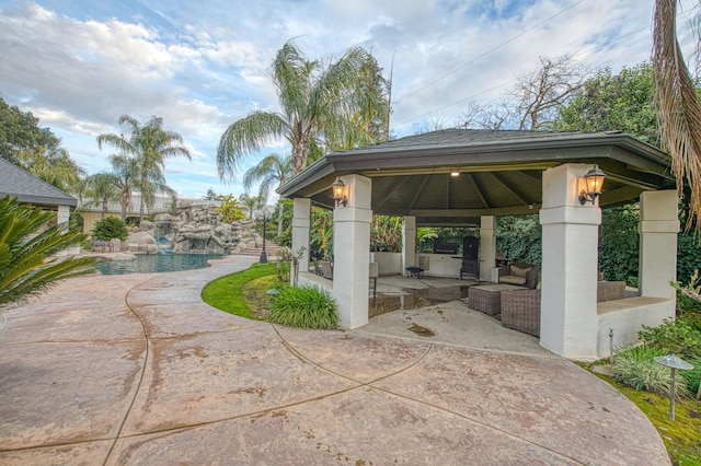 view of community featuring outdoor lounge area, fence, a gazebo, a patio area, and a pool