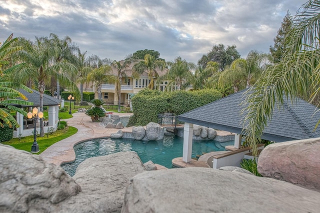 outdoor pool with a patio area and fence