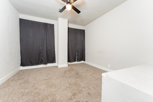 unfurnished bedroom featuring carpet, visible vents, ceiling fan, and baseboards