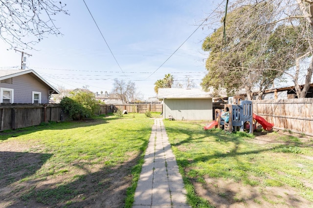 view of yard with a playground and a fenced backyard