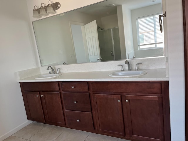 bathroom featuring double vanity, tile patterned flooring, and a sink