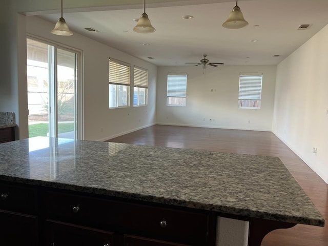 kitchen with visible vents, open floor plan, and decorative light fixtures