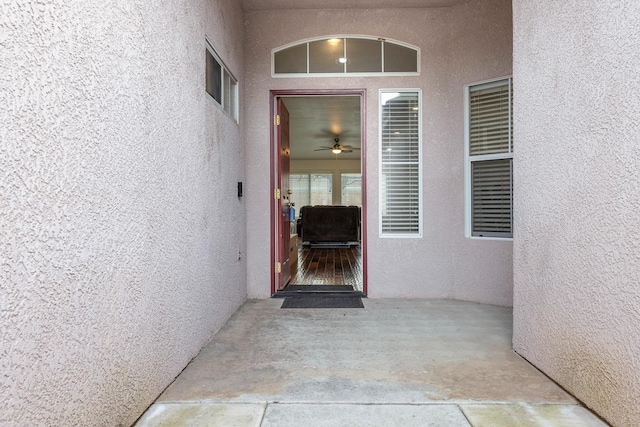 property entrance featuring a patio and stucco siding