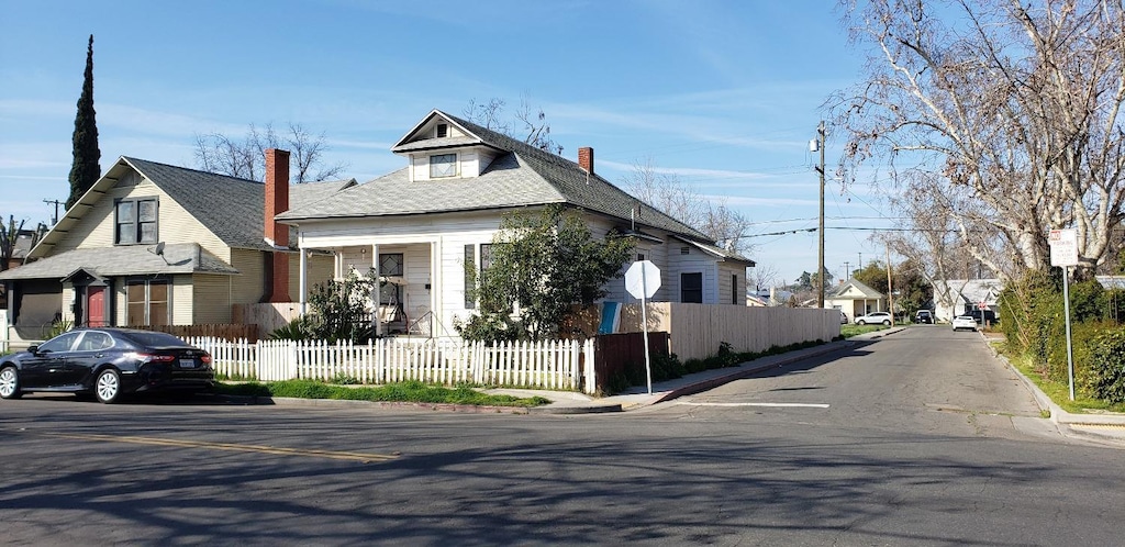 exterior space featuring a fenced front yard and a residential view