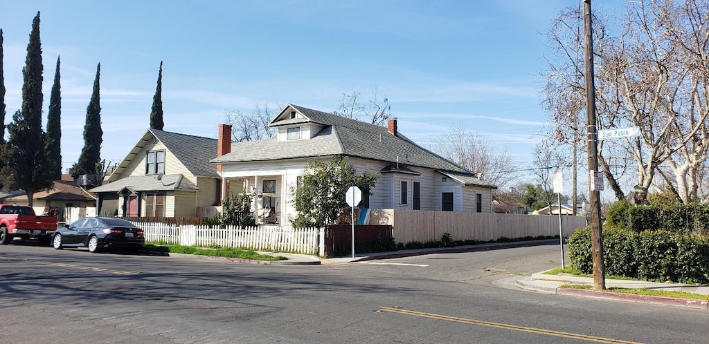 view of front of house with a fenced front yard and a chimney