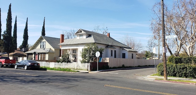 view of front of house with a fenced front yard and a chimney