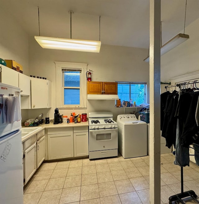 385 N San Pablo Ave, Fresno, CA 93701 - kitchen featuring light tile patterned floors, light countertops, freestanding refrigerator, white gas range, and washer / dryer