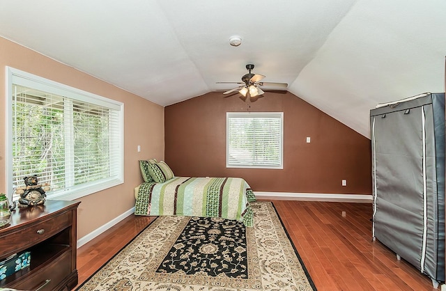 bedroom with lofted ceiling, wood finished floors, a ceiling fan, and baseboards