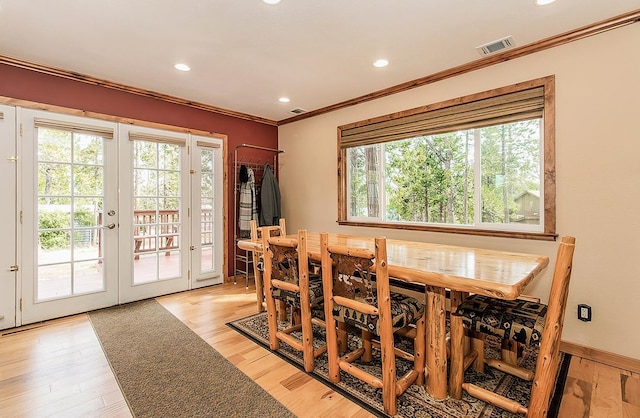 dining space featuring light wood-style flooring, recessed lighting, visible vents, french doors, and ornamental molding