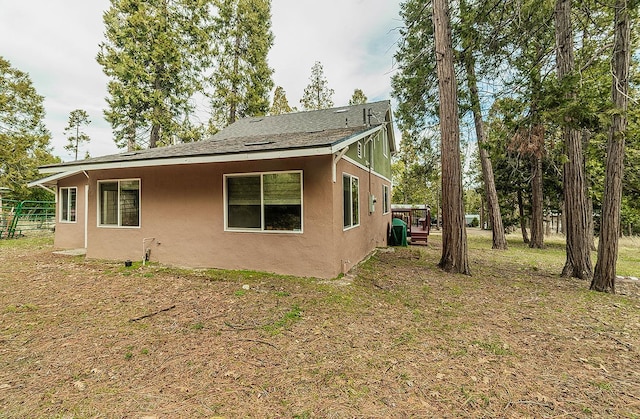 view of property exterior with a yard and stucco siding