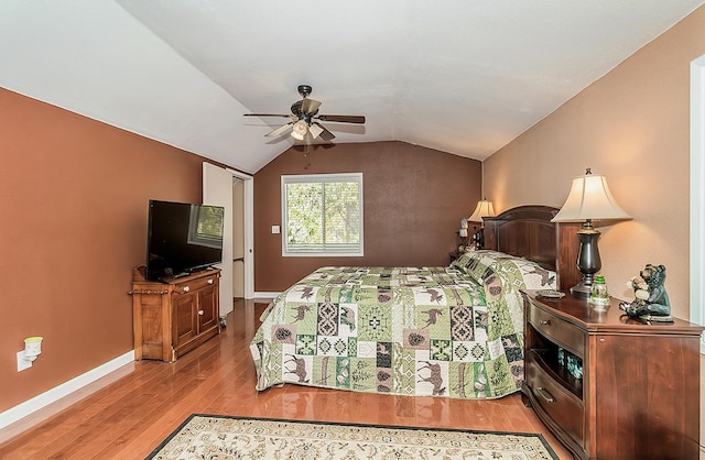 bedroom featuring light wood-type flooring, ceiling fan, lofted ceiling, and baseboards