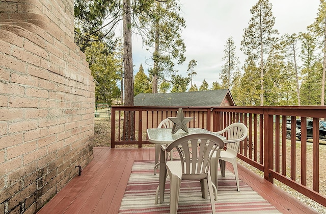 wooden terrace featuring outdoor dining space