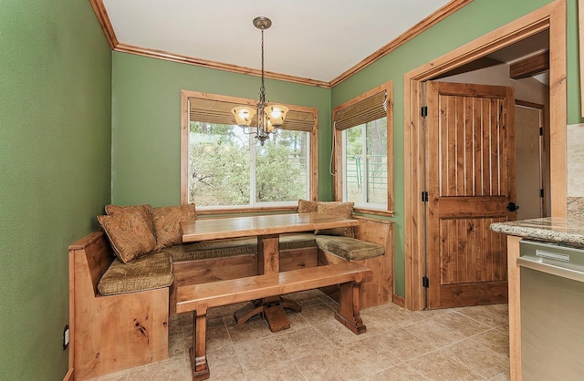 dining area featuring breakfast area, a notable chandelier, and crown molding