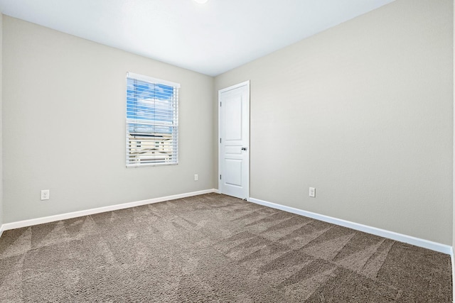 empty room with carpet floors and baseboards