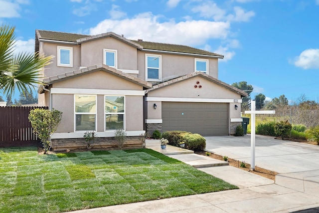 view of front facade with fence, driveway, a front lawn, and stucco siding