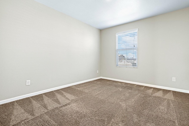 carpeted empty room with baseboards