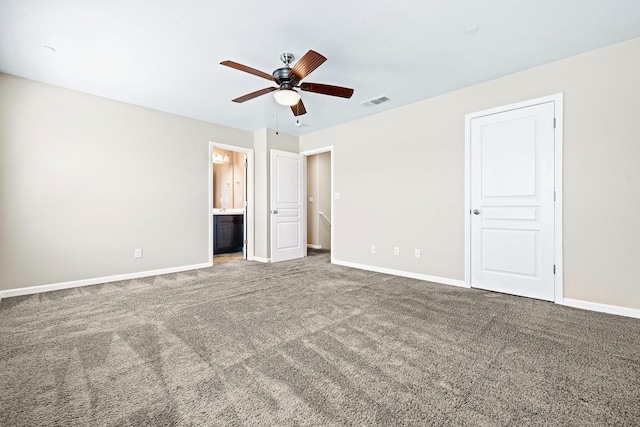 unfurnished bedroom featuring carpet floors, connected bathroom, visible vents, and baseboards