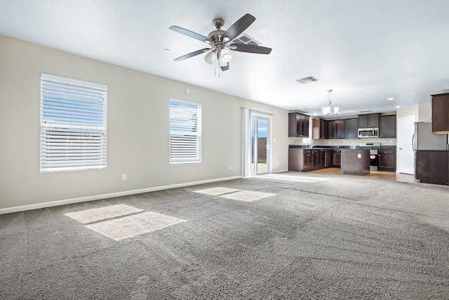 unfurnished living room featuring light carpet, ceiling fan, visible vents, and baseboards