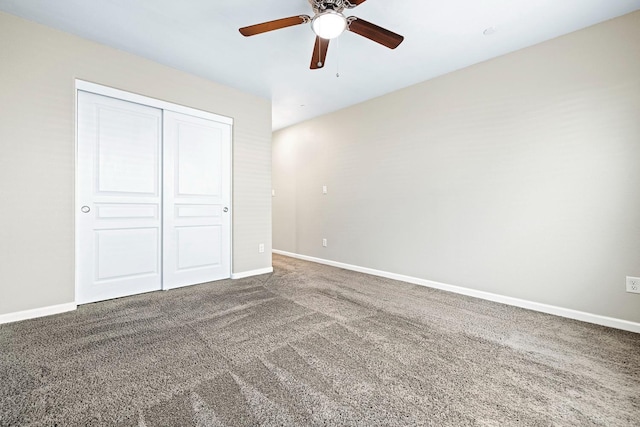 unfurnished bedroom with ceiling fan, carpet floors, a closet, and baseboards