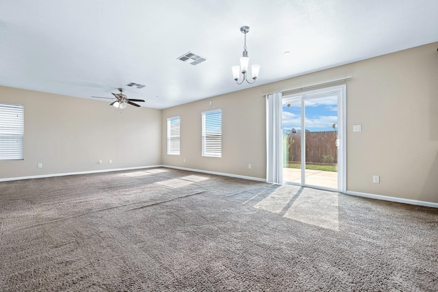 carpeted spare room with visible vents, baseboards, and ceiling fan with notable chandelier