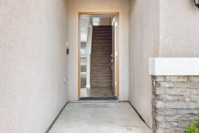 property entrance with stucco siding