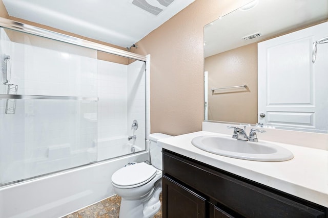 full bath featuring visible vents, toilet, shower / bath combination with glass door, stone finish flooring, and vanity