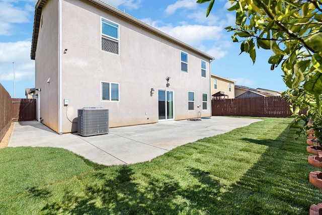 rear view of property with cooling unit, a fenced backyard, and stucco siding