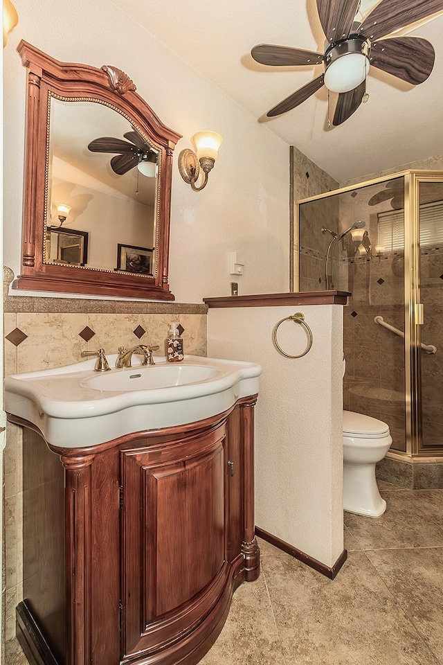 full bathroom with a ceiling fan, toilet, a shower stall, and vanity