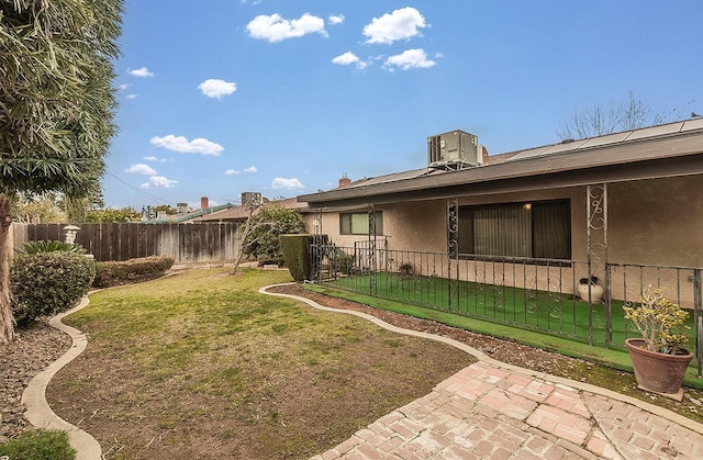 view of yard featuring cooling unit and fence