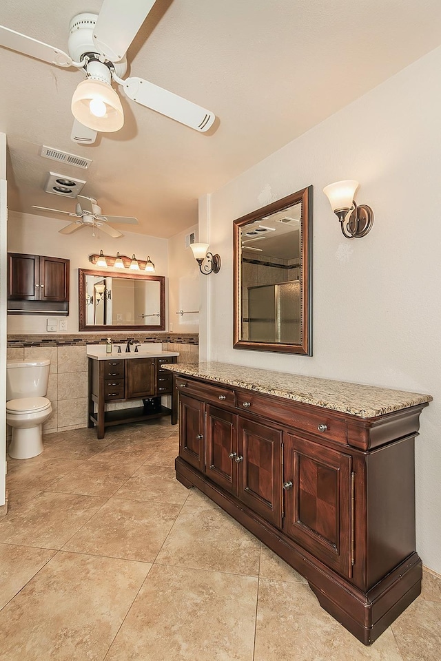 full bathroom with visible vents, a ceiling fan, toilet, tile patterned floors, and vanity