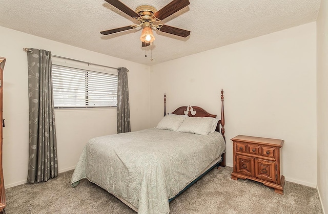 bedroom with light carpet, a textured ceiling, and baseboards