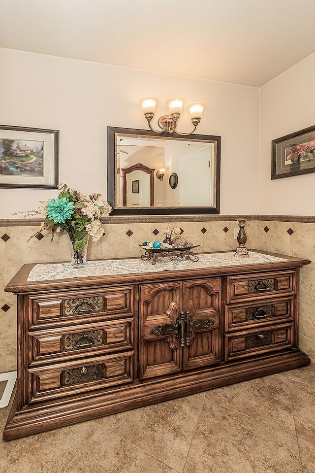 bathroom with tile walls, wainscoting, and vanity