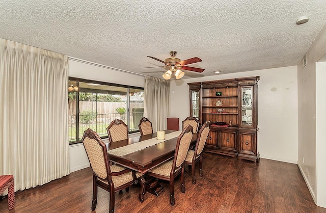 dining space featuring a textured ceiling, dark wood finished floors, and baseboards