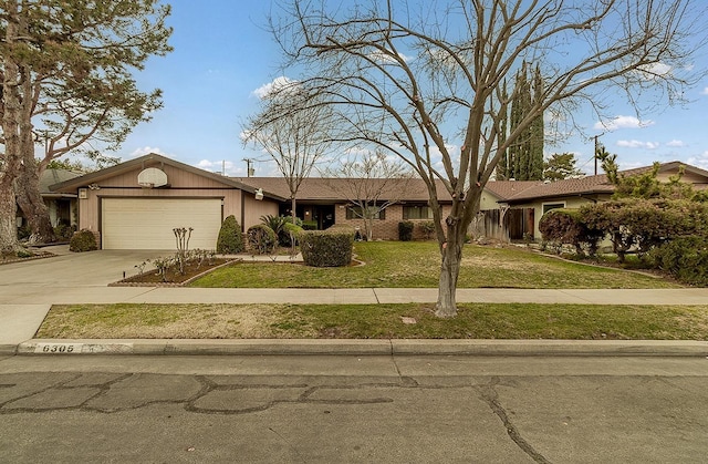 ranch-style house featuring concrete driveway, brick siding, an attached garage, and a front lawn