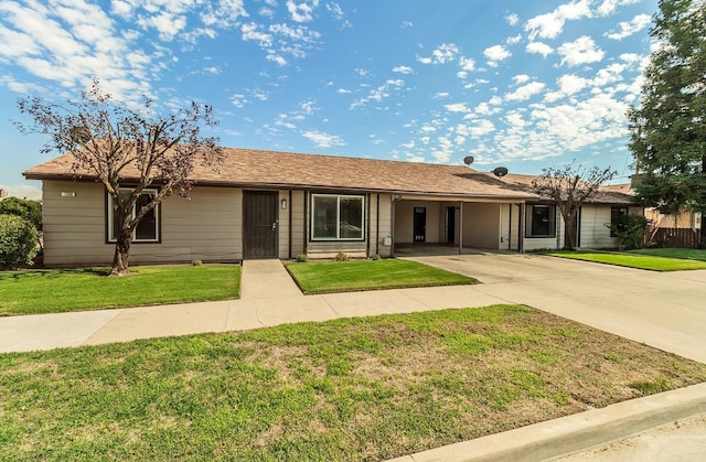 single story home featuring driveway, a carport, and a front yard