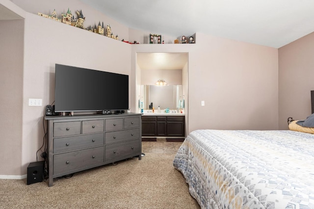 bedroom with light carpet and ensuite bath