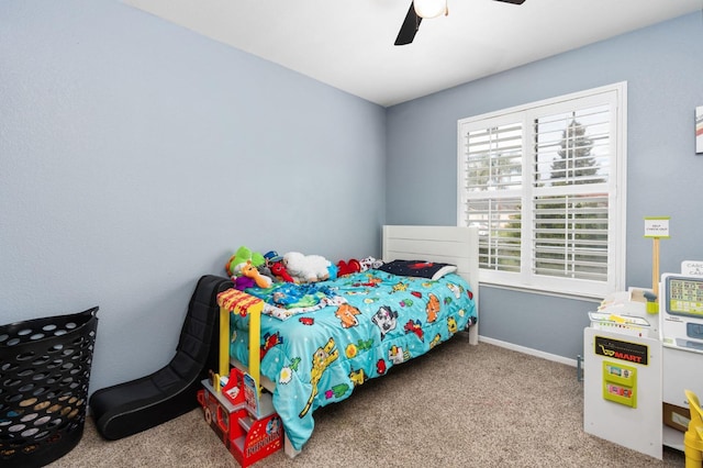 bedroom featuring a ceiling fan, light carpet, and baseboards