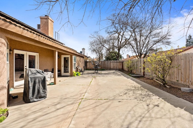 view of patio / terrace featuring a fenced backyard and french doors