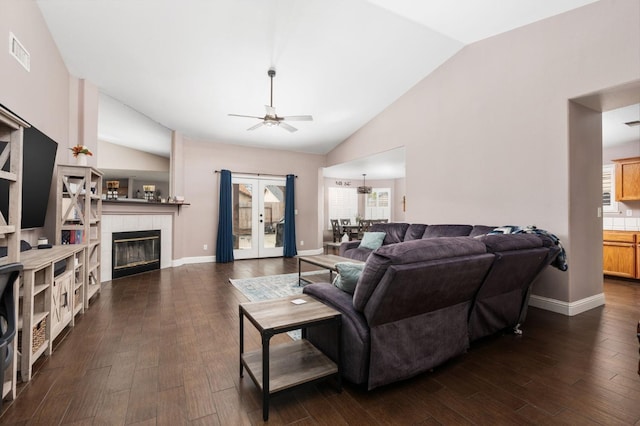 living room featuring a tile fireplace, dark wood-style flooring, visible vents, a ceiling fan, and french doors