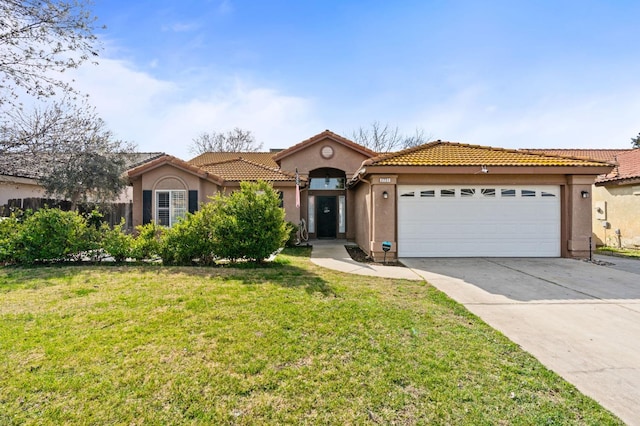 mediterranean / spanish house with driveway, a front lawn, an attached garage, and stucco siding