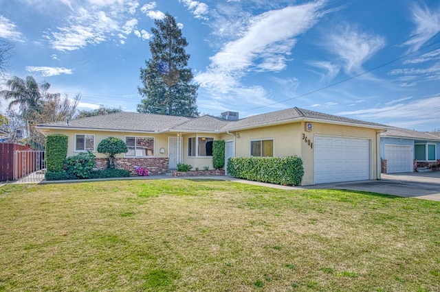 single story home with an attached garage, driveway, a front yard, and stucco siding