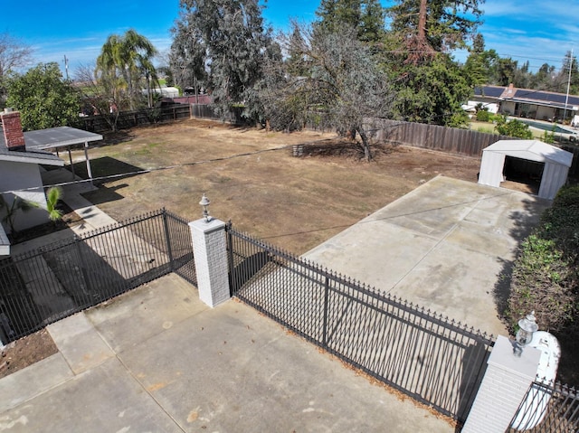 exterior space featuring a fenced backyard and an outbuilding