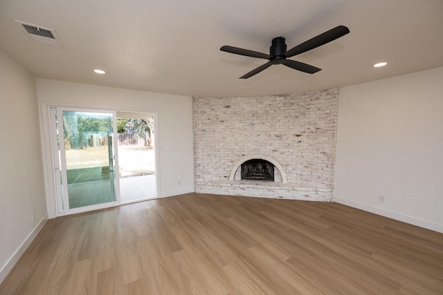 unfurnished living room with a fireplace, recessed lighting, visible vents, light wood-type flooring, and baseboards