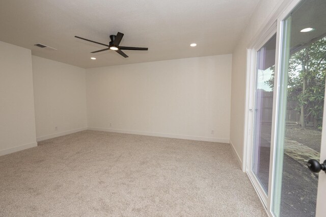 empty room with baseboards, recessed lighting, visible vents, and light colored carpet