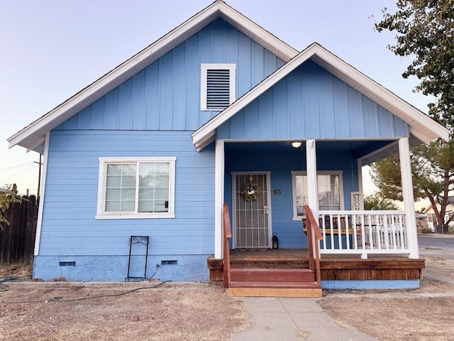 bungalow with covered porch, crawl space, and board and batten siding