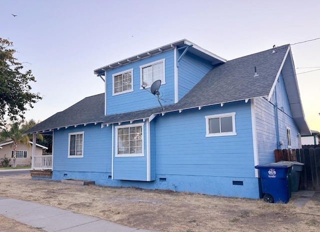 rear view of property featuring crawl space and a shingled roof