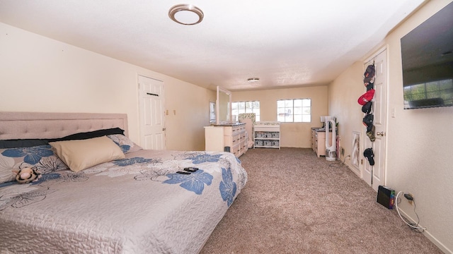 bedroom featuring carpet and baseboards